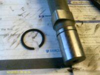 New camshaft and circlip showing circlip groove.