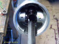Pinch bolt inside piston.